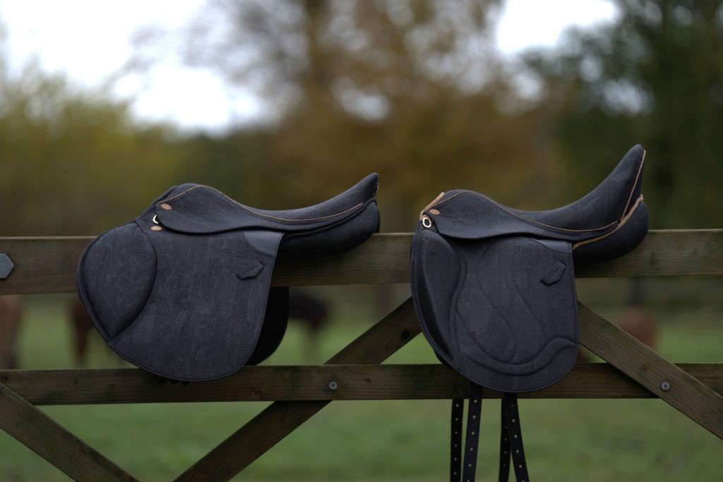 Zwei Korksättel schwarz auf Holzgelände